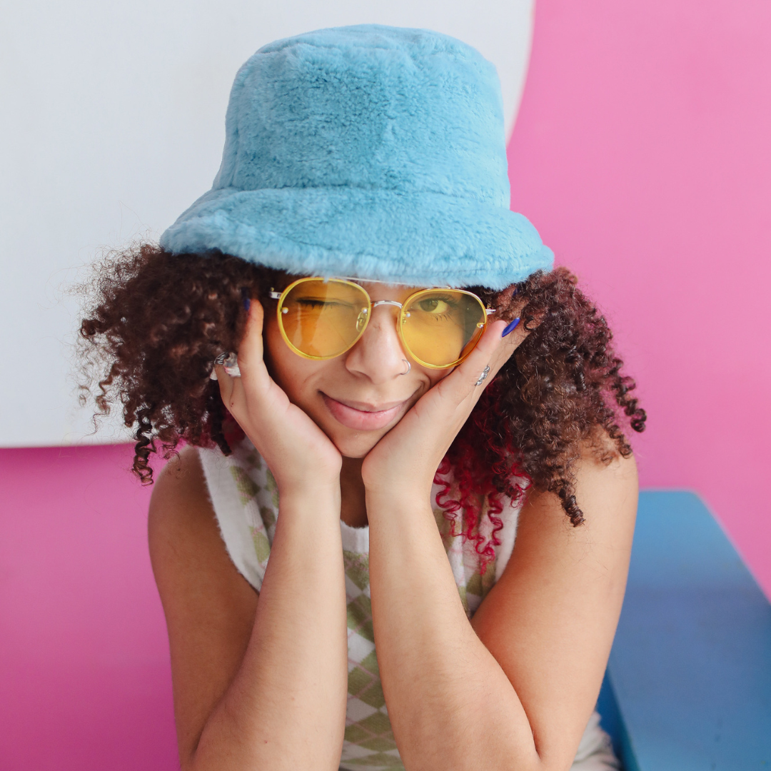 young girl wearing hat and glasses